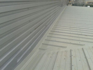 In-situ weathering to abutment detail and deflector, Kingspan KS1000RW roofsheet, for Construction Profiles in Northampton