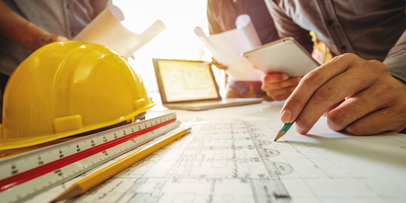 Three technical leads examining roof details for a roofing project
