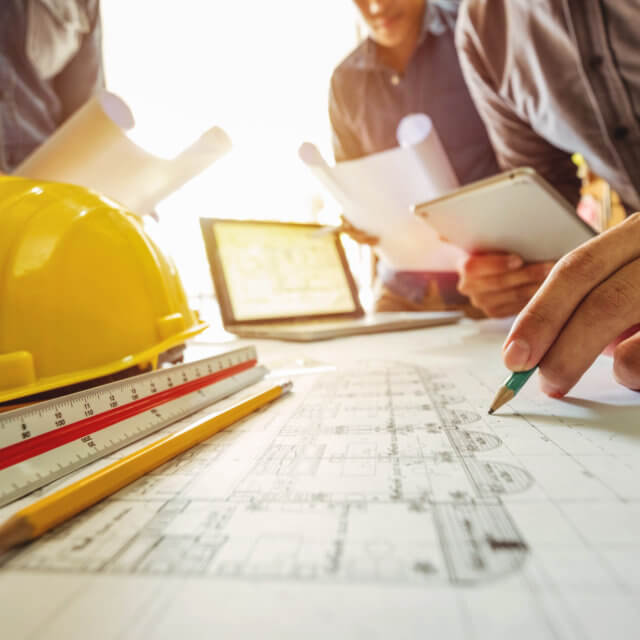 Three technical leads examining roof details for a roofing project